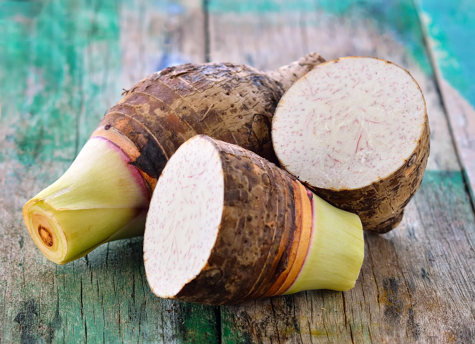 Whole and cut tubers on a wooden table